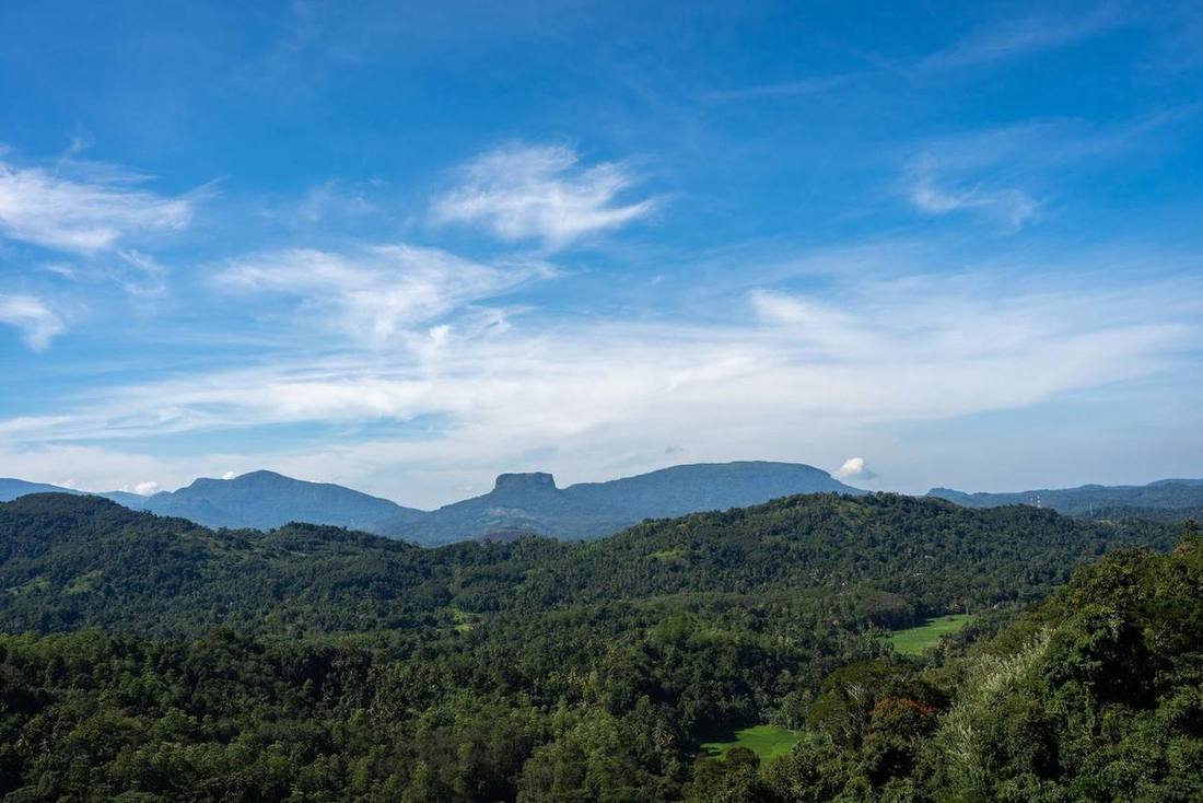 Green hills under a blue sky